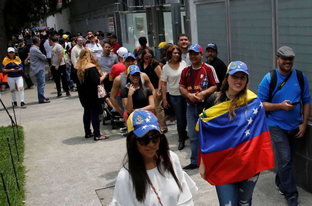 General view shows people wait to cast their votes during an unofficial plebiscite against Venezuela’s President Nicolas Maduro’s government, in Mexico City