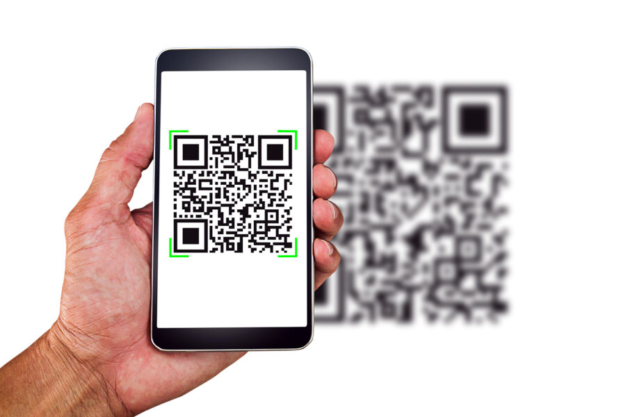 Hand holding smartphone scanning QR code on white background, business concept