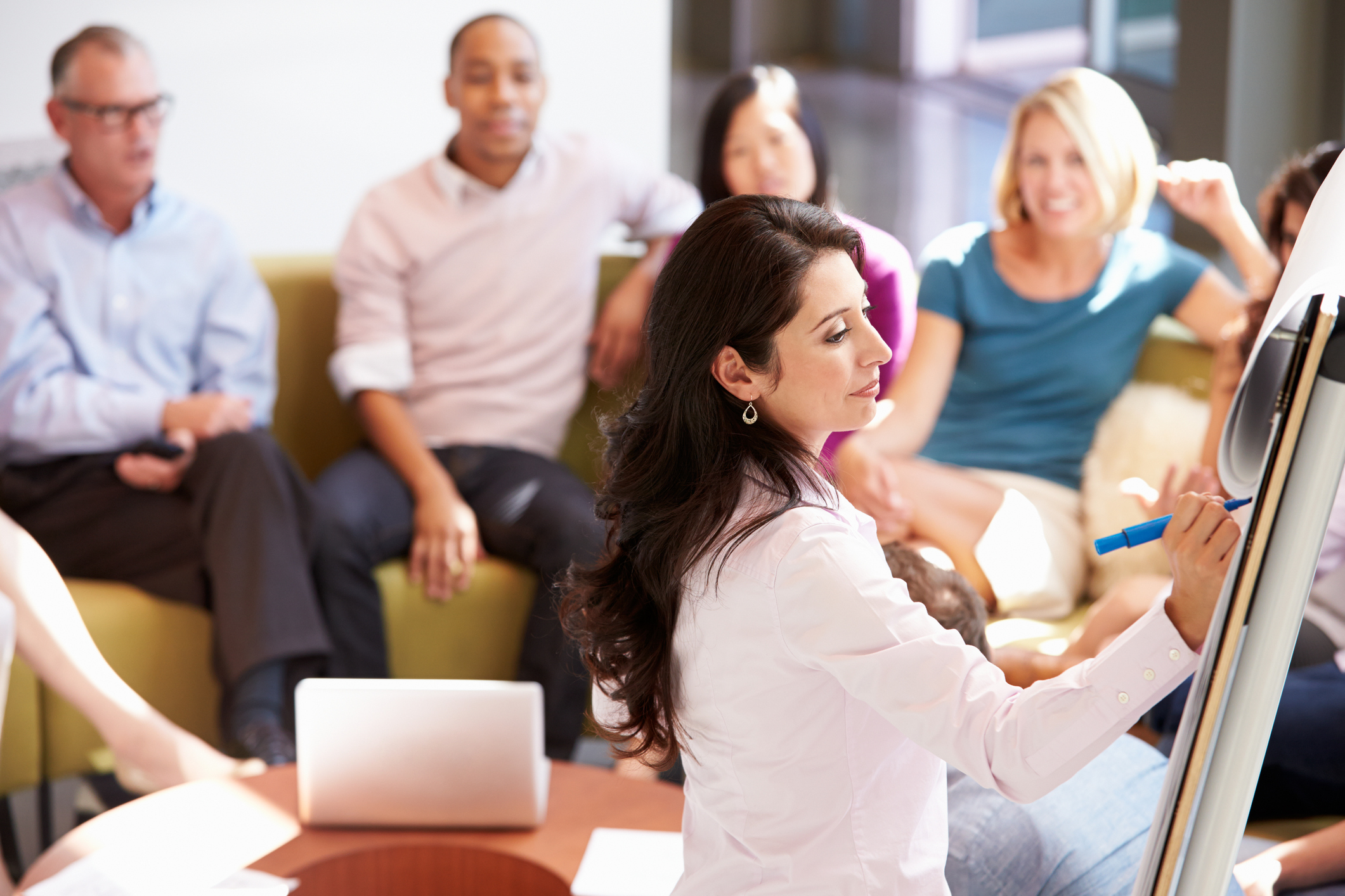 Businesswoman Making Presentation To Office Colleagues